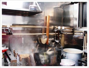 Japanese Restaurants in Tokyo Menmen Kamezo interior  kitchen area  pot with boiling water  for cooking ramen noodles